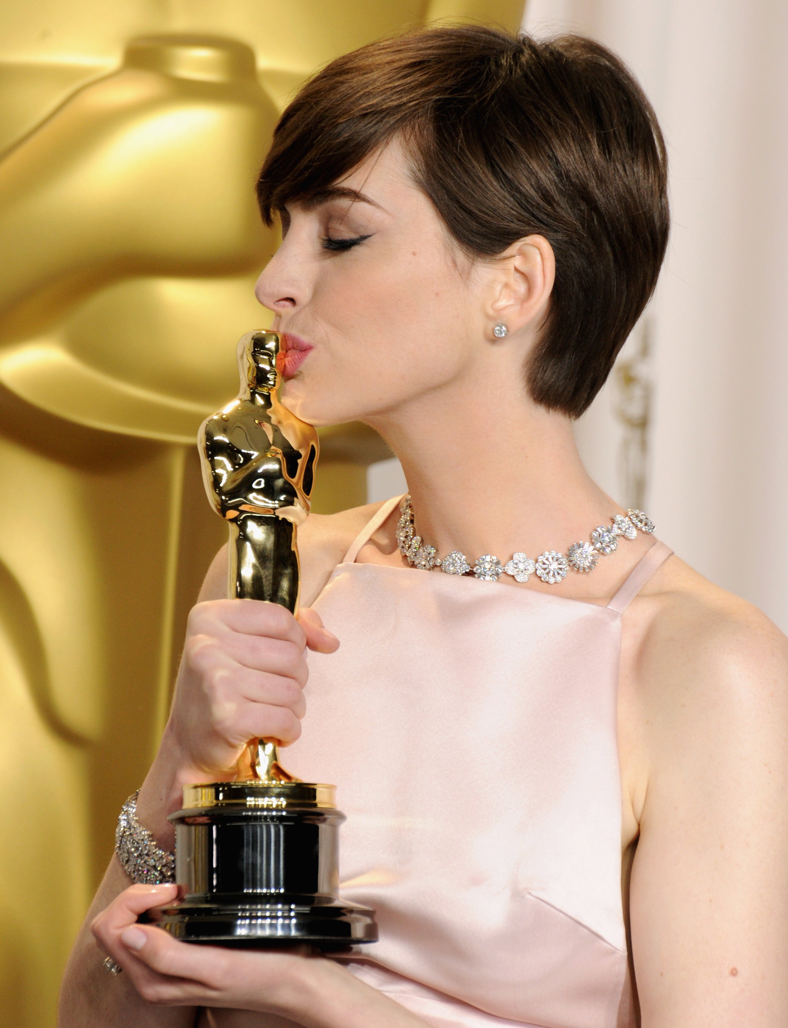 Anne Hathaway kissing her Oscar