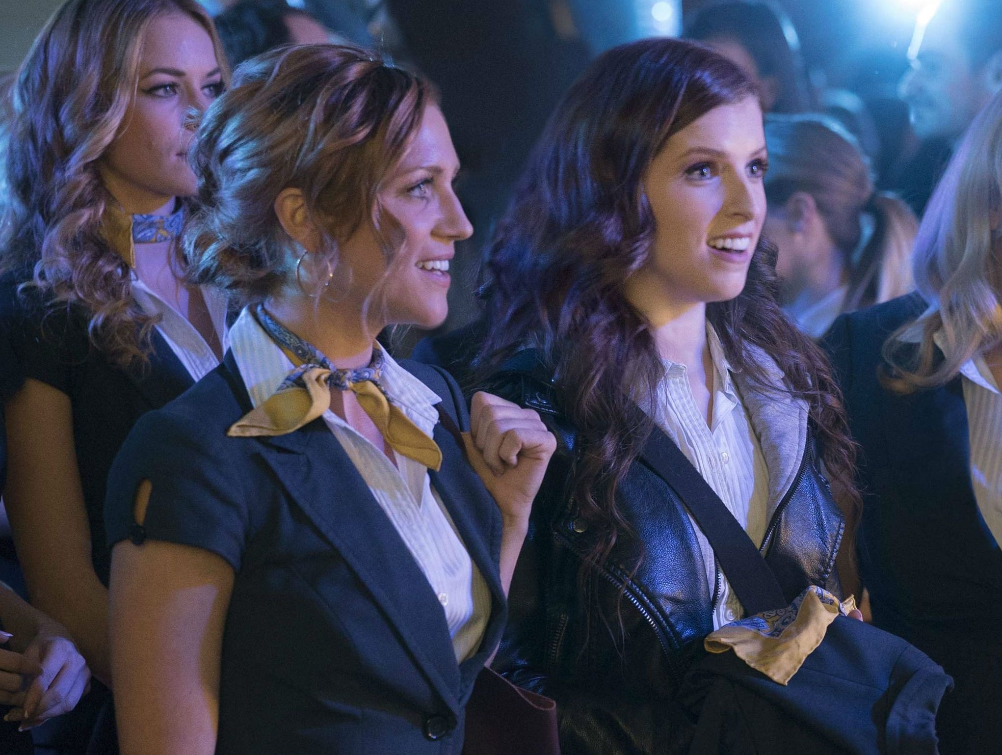 Anna Kendrick and Brittany Snow in character at an event in the movie &quot;Pitch Perfect&quot;. They wear matching outfits with scarves