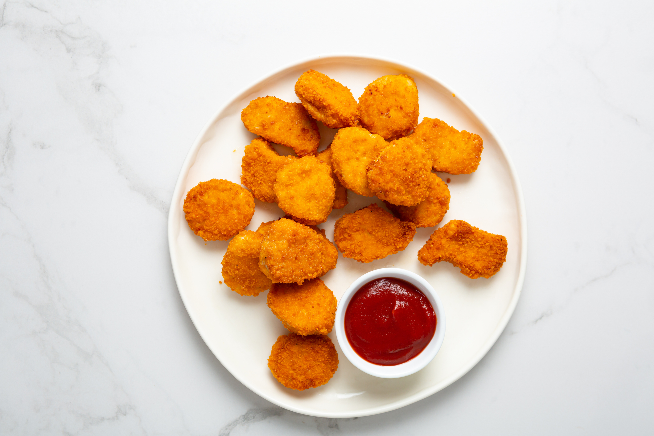 Plate of chicken nuggets with a side of ketchup