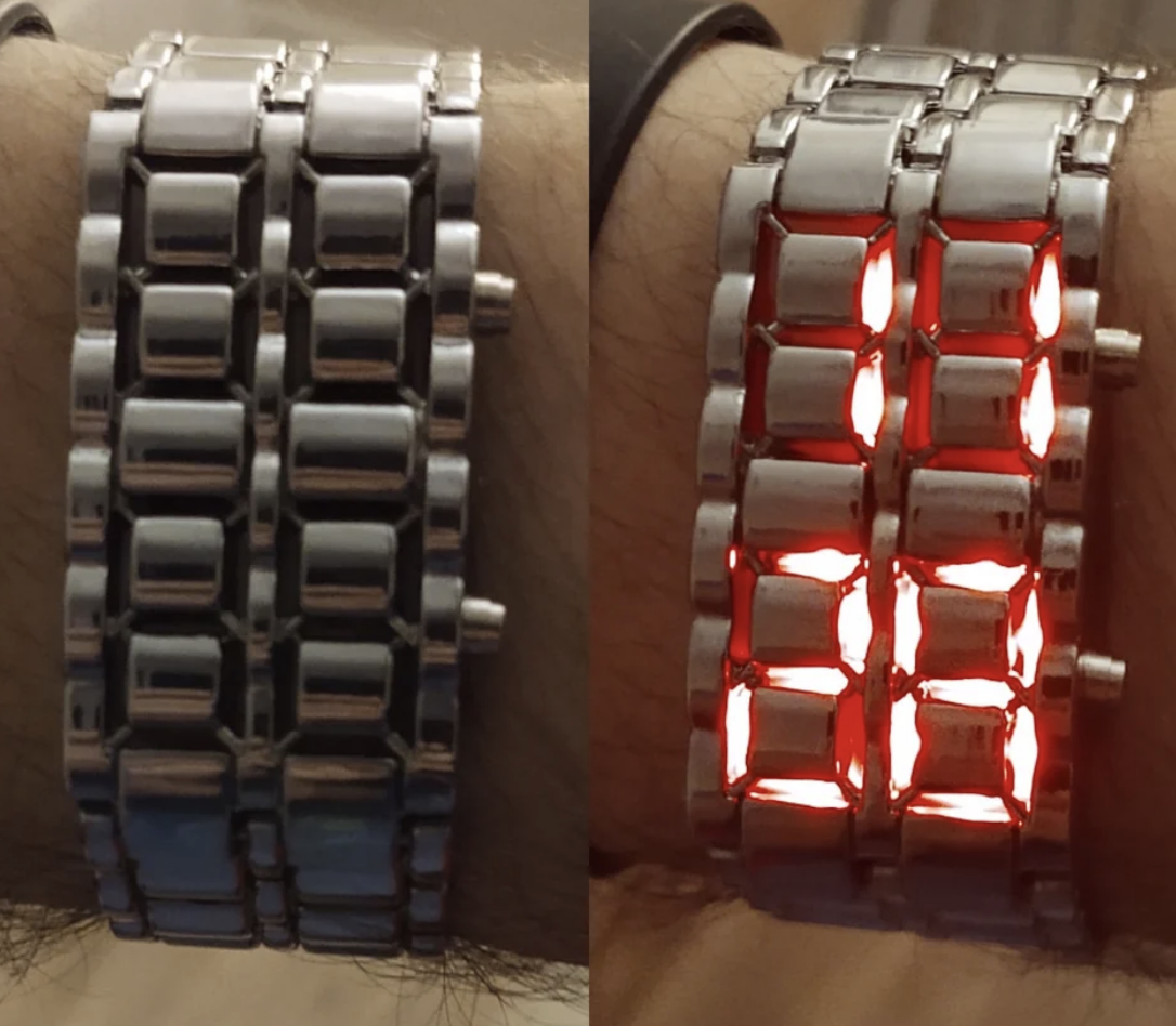 A wrist wearing a digital watch with illuminated red LED bars to indicate the time