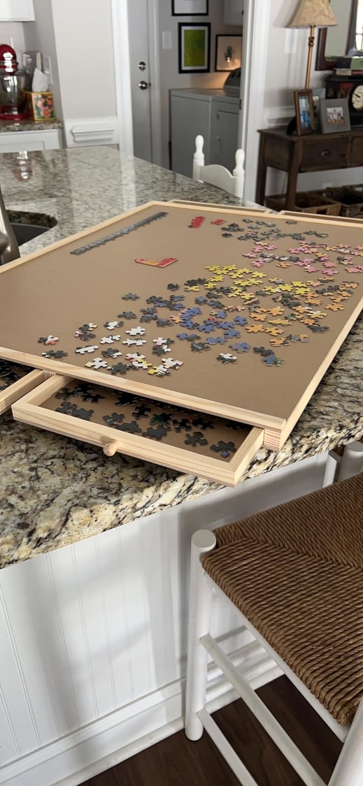 Jigsaw puzzle partially completed on an easel in a home kitchen
