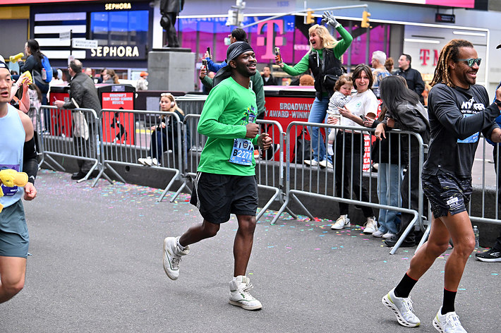 Runners in an urban marathon event, wearing athletic gear and sneakers, focused and enjoying the race