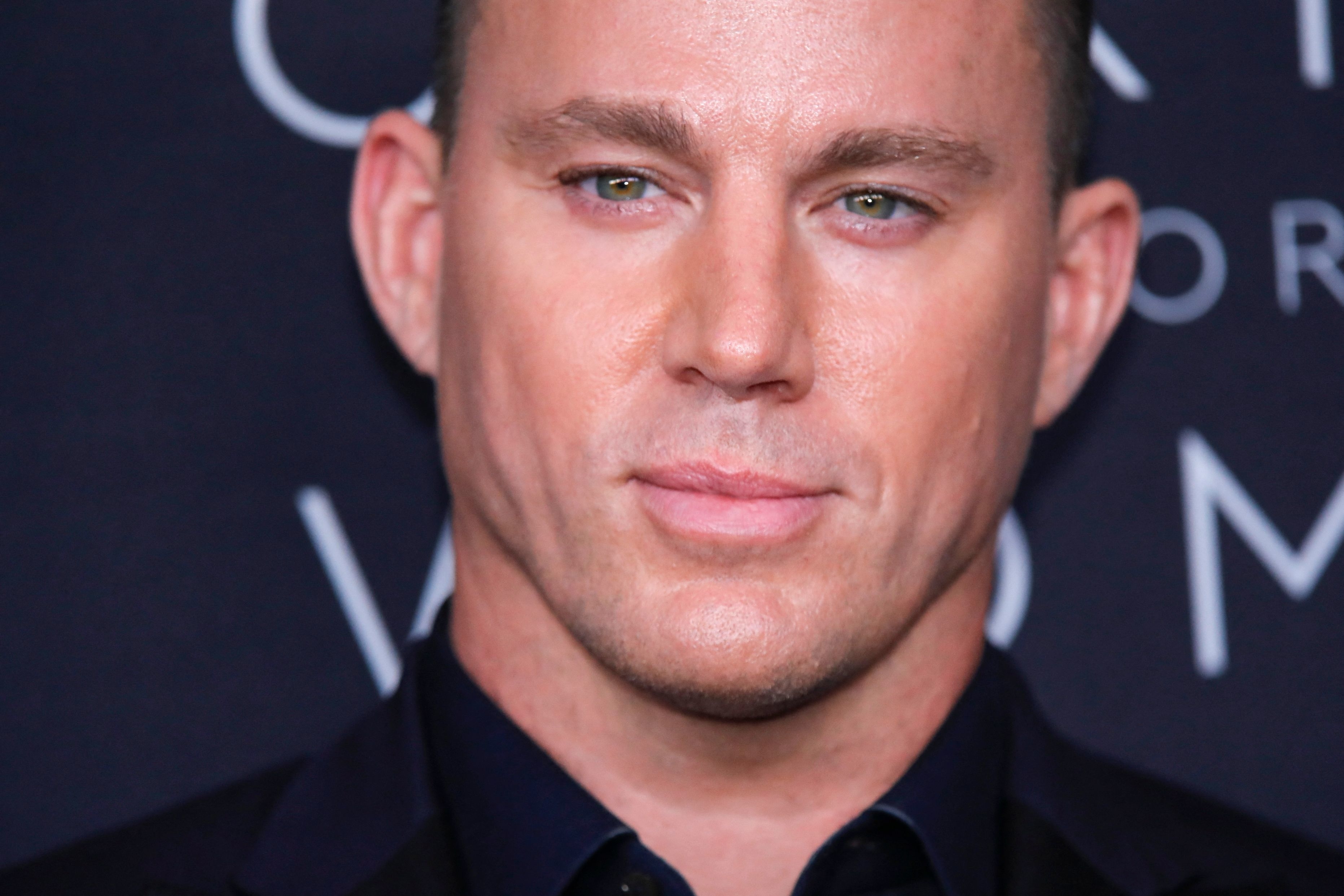 Close-up of Channing Tatum wearing a dark suit with a subtle pattern at an event
