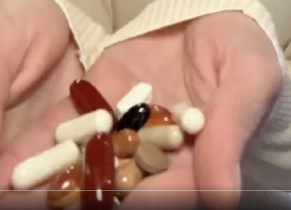 Close-up of various pills and capsules in Bella&#x27;s hand