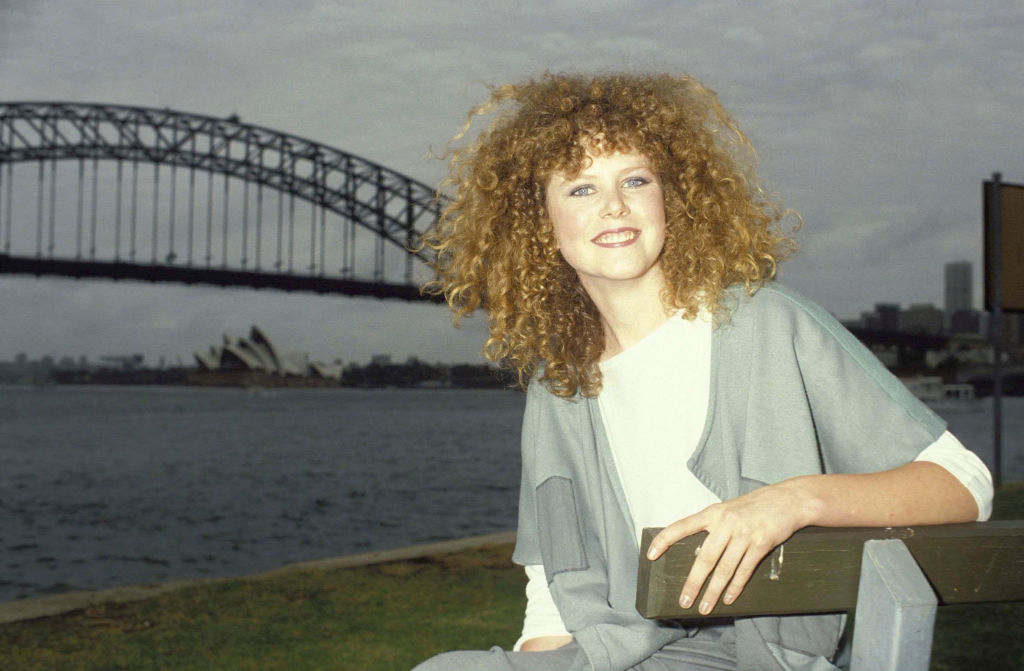 Nicole posing in front of Sydney Harbour with the Opera House and Harbour Bridge in the background