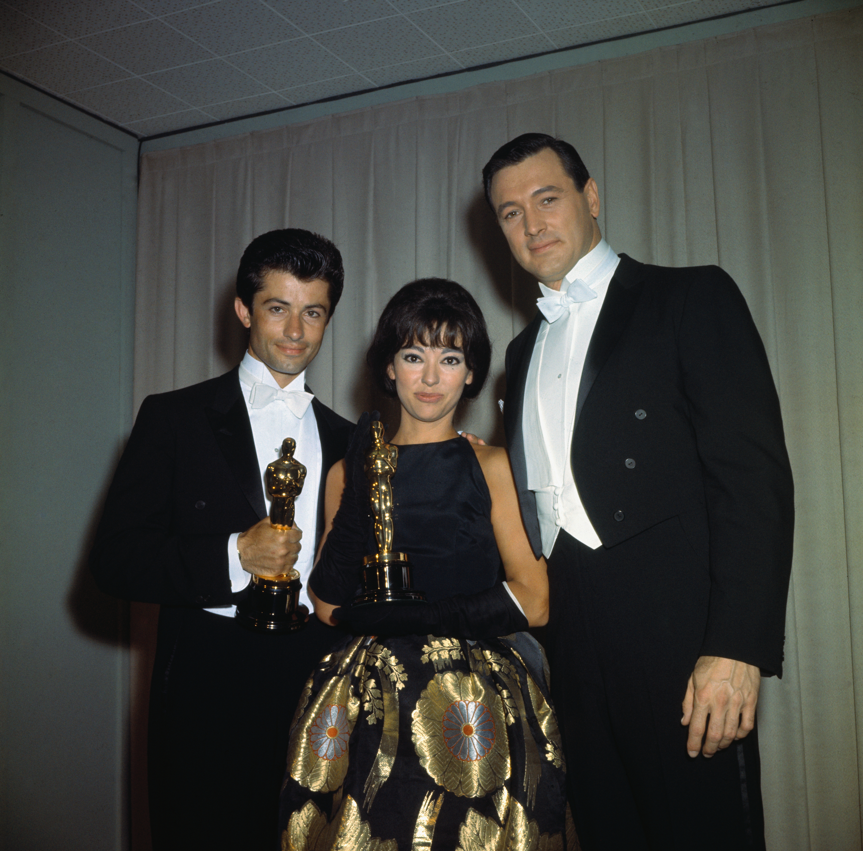 Rita Moreno with two men, holding their Oscars