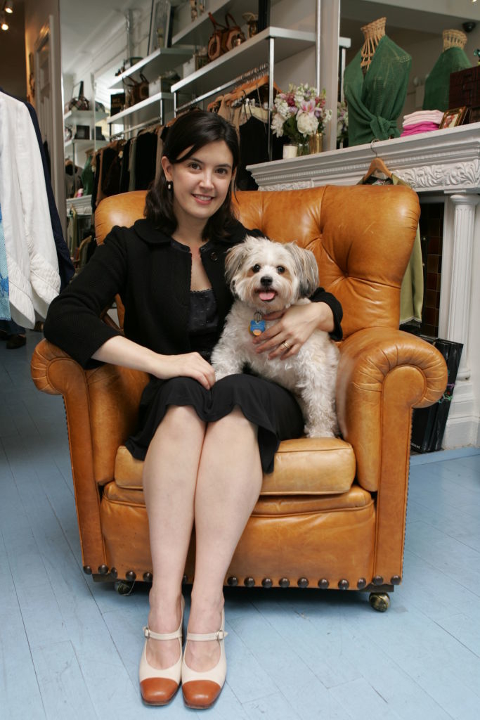 Phoebe seated with a dog on an armchair
