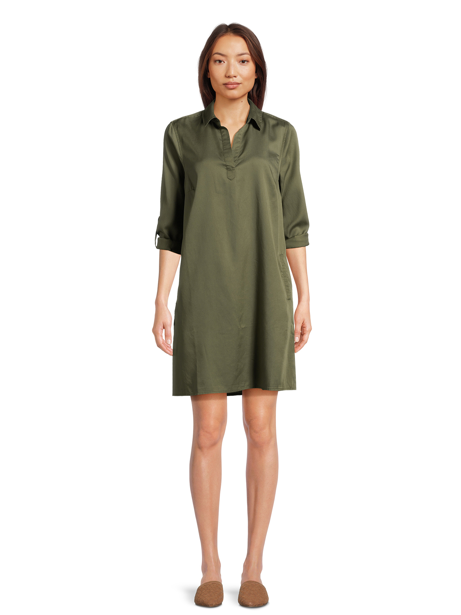 person in a knee-length shirt dress with three-quarter sleeves and collar, paired with flat shoes