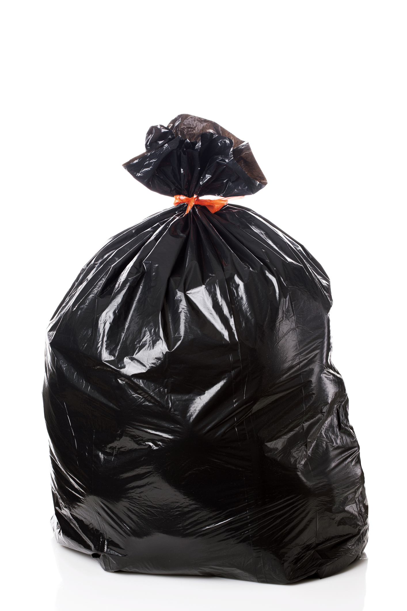 A sealed black trash bag tied with a red band, isolated on a white background