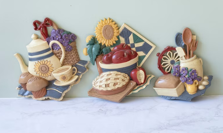Decorative wall art featuring a collection of stylized kitchen items and food