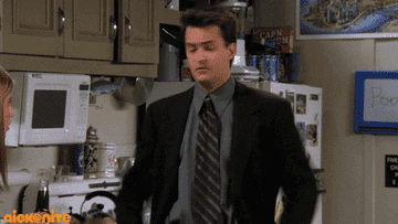 Chandler Bing from Friends sitcom dances in a kitchen while Rachel Greene watches
