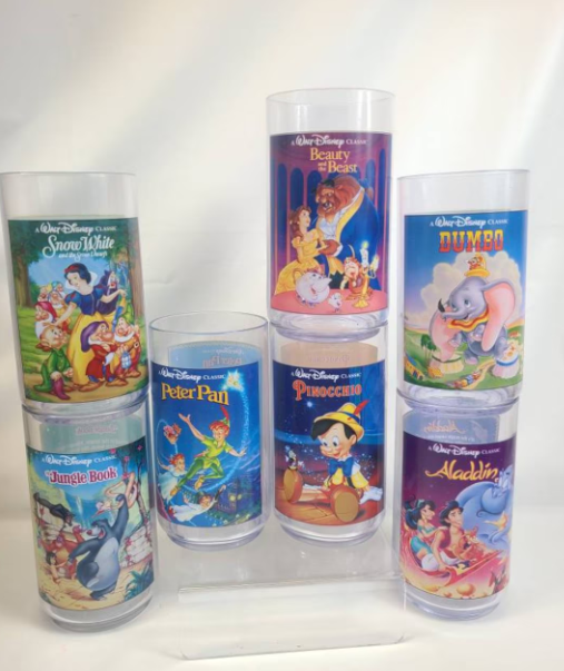 Collection of Disney glasses featuring characters from Snow White, Beauty and the Beast, Dumbo, Peter Pan, Pinocchio, Jungle Book, and Aladdin