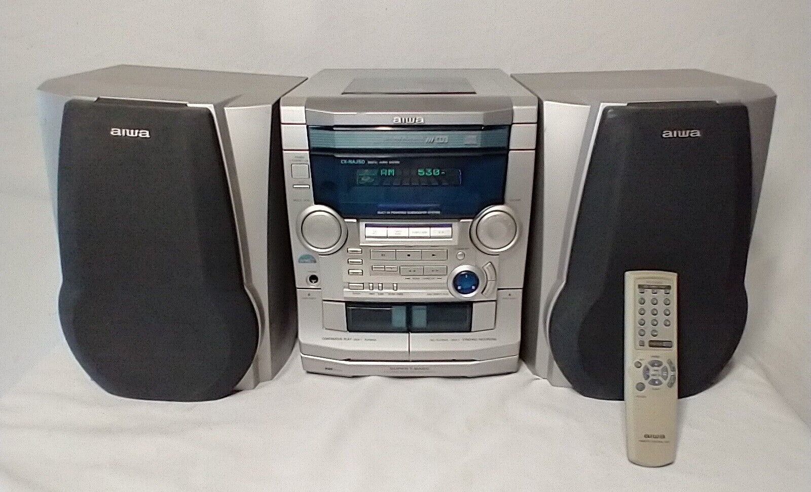 Aiwa stereo system with two speakers and a remote control from the late 1990s to early 2000s
