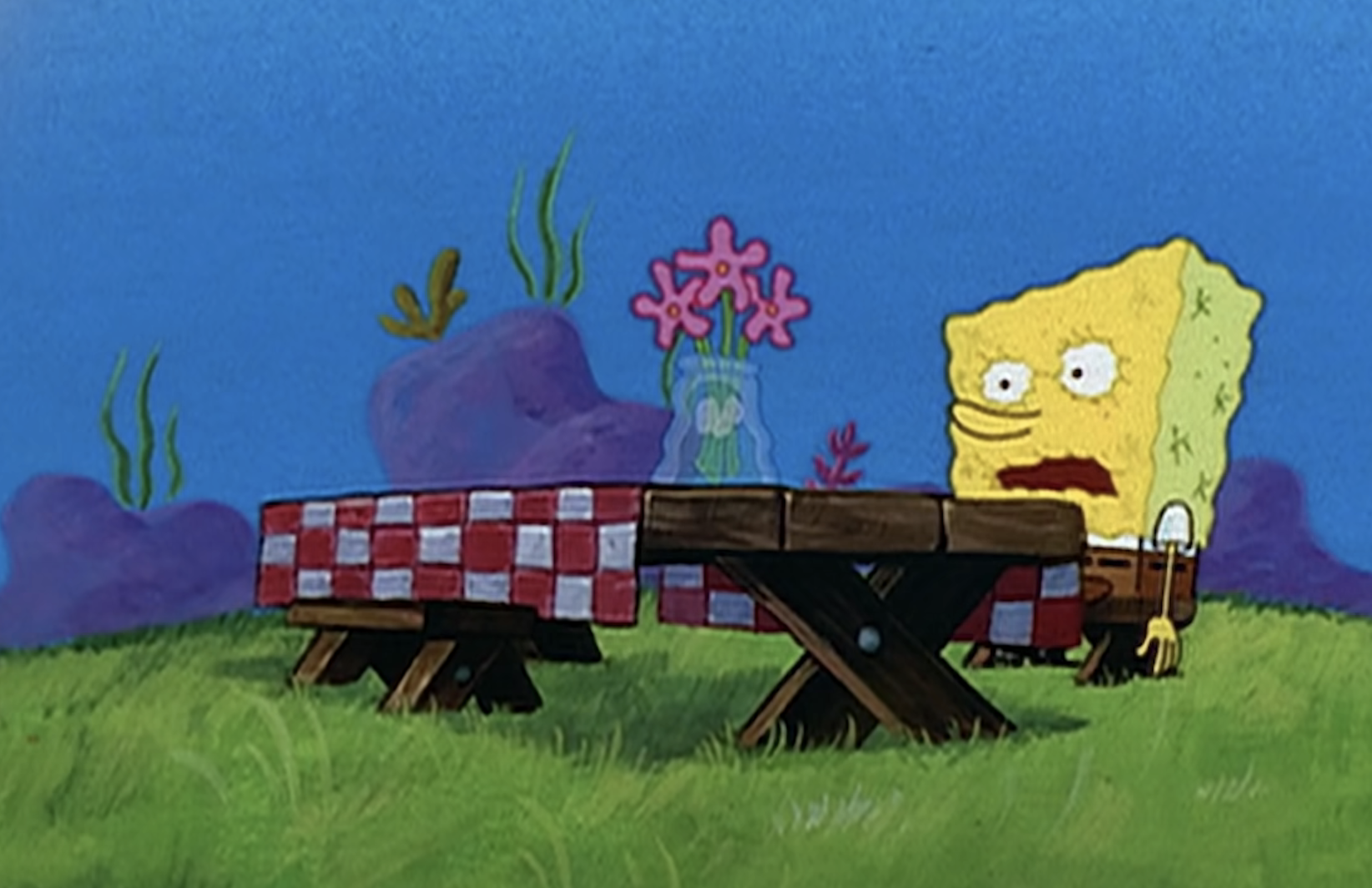 SpongeBob sitting at a picnic table looking disappointed, with Squidward standing behind the table