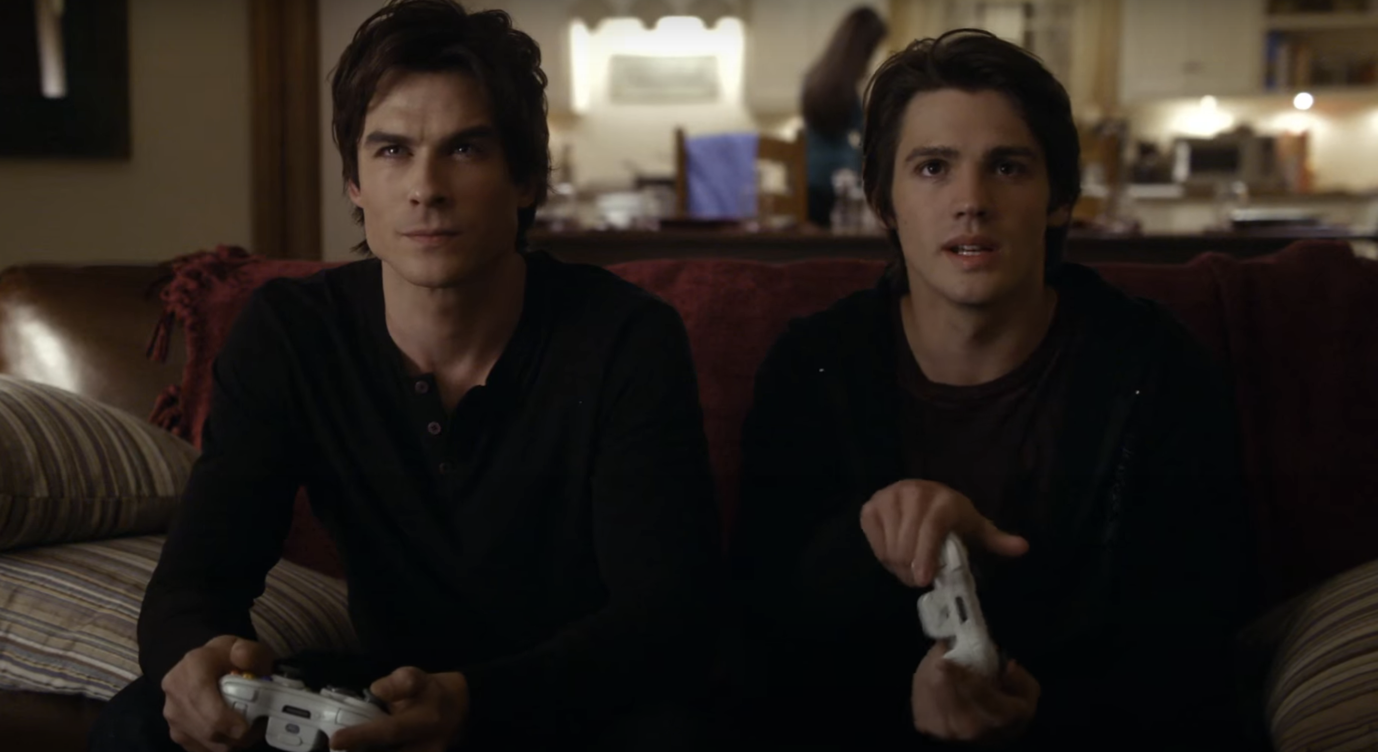 Damon and Stefan from The Vampire Diaries playing video games on a couch