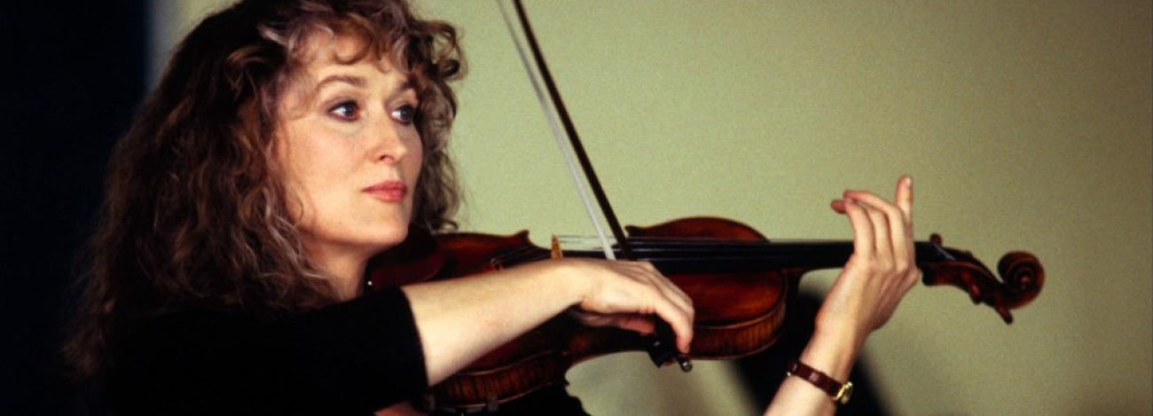Woman playing violin with focused expression