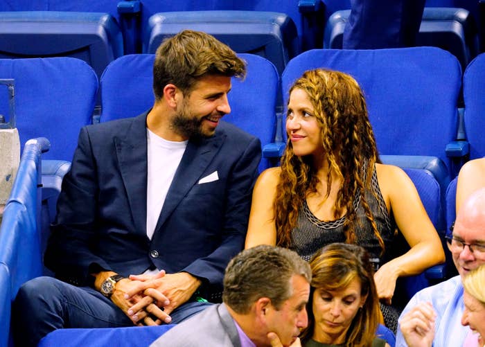 Closeup of Gerard Piqué and Shakira sitting at a sports event