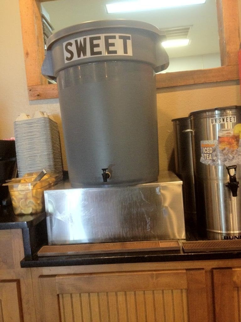 Dispensers labeled &quot;SWEET&quot; and &quot;UNSWEET&quot; for iced tea, with cups and lemon slices available