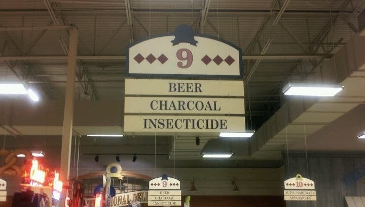 Aisle sign in a store indicating Beer, Charcoal, Insecticide available in aisle 9
