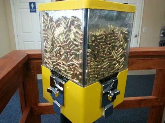 A vending machine filled with bullets instead of candy, placed indoors
