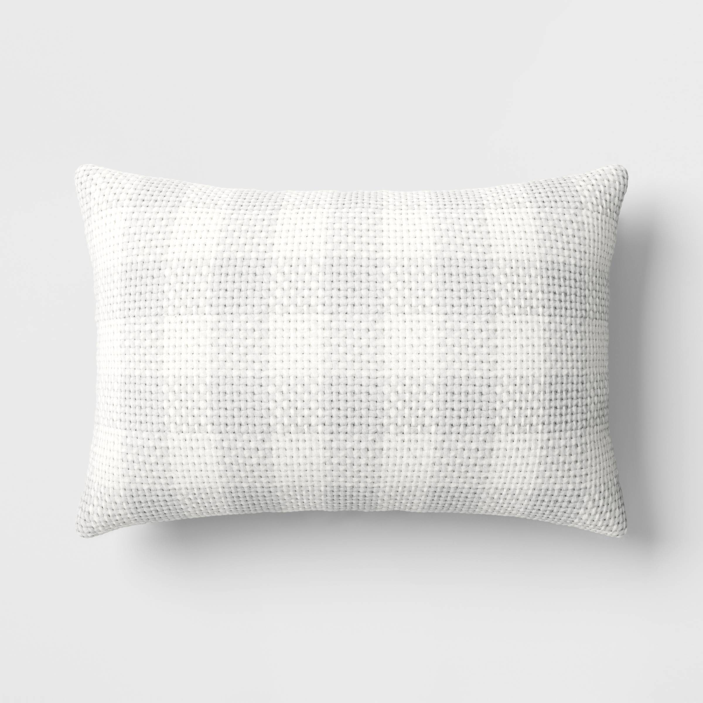 A white textured pillow on a solid background