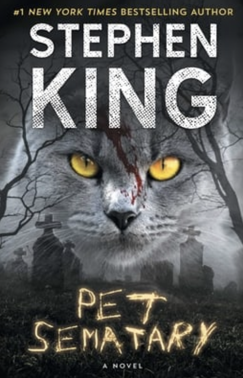 Book cover of Stephen King&#x27;s &quot;Pet Sematary&quot; with a cat&#x27;s face and a spooky backdrop