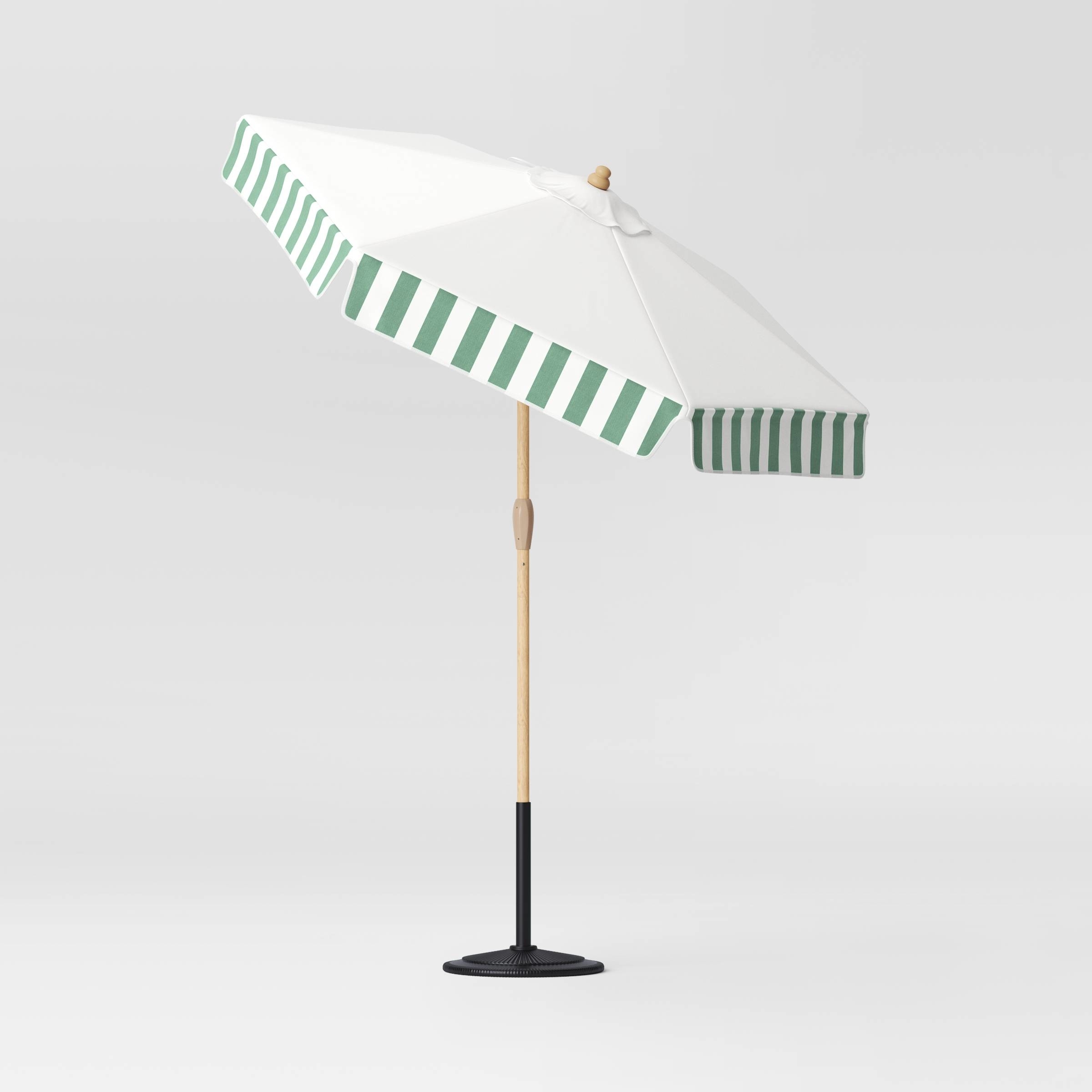 A white patio umbrella with green stripes on a plain background