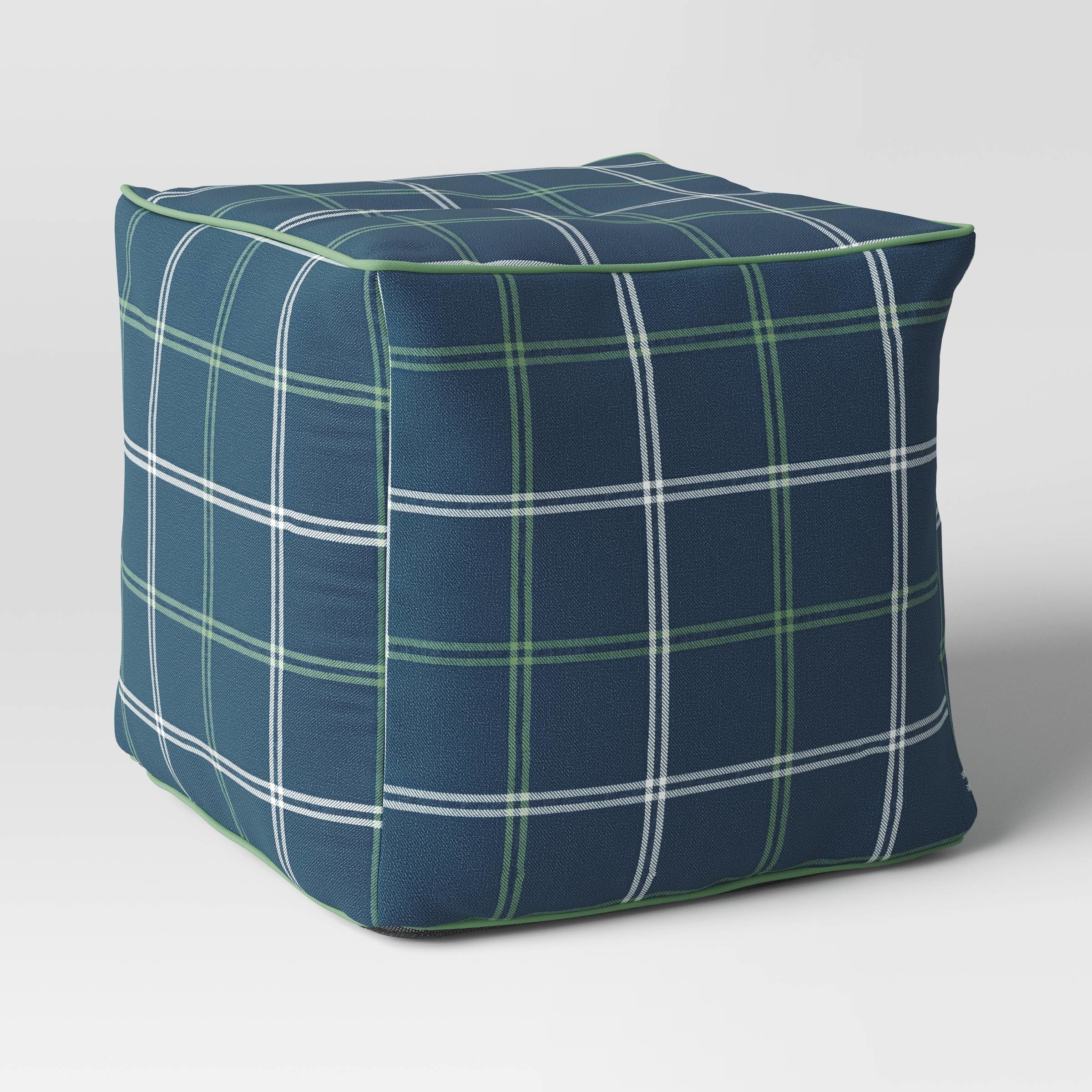 A plaid-patterned square ottoman on a plain background