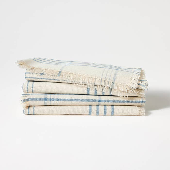 Stacked striped towels on a plain background