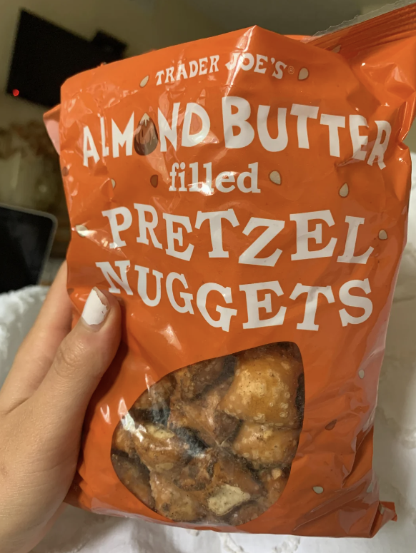 Hand holding a bag of Trader Joe&#x27;s Almond Butter Filled Pretzel Nuggets