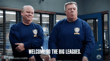 Hitchcock and Scully from Brooklyn Nine-Nine wear NYPD uniforms, doing a fist bump. Text: &quot;Welcome to the big leagues. #Brooklyn99&quot;