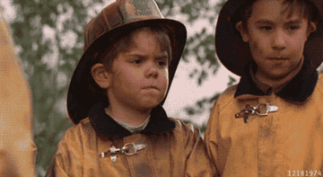 gif of child from the little rascals movie wearing firefighter outfit and waxing goodbye