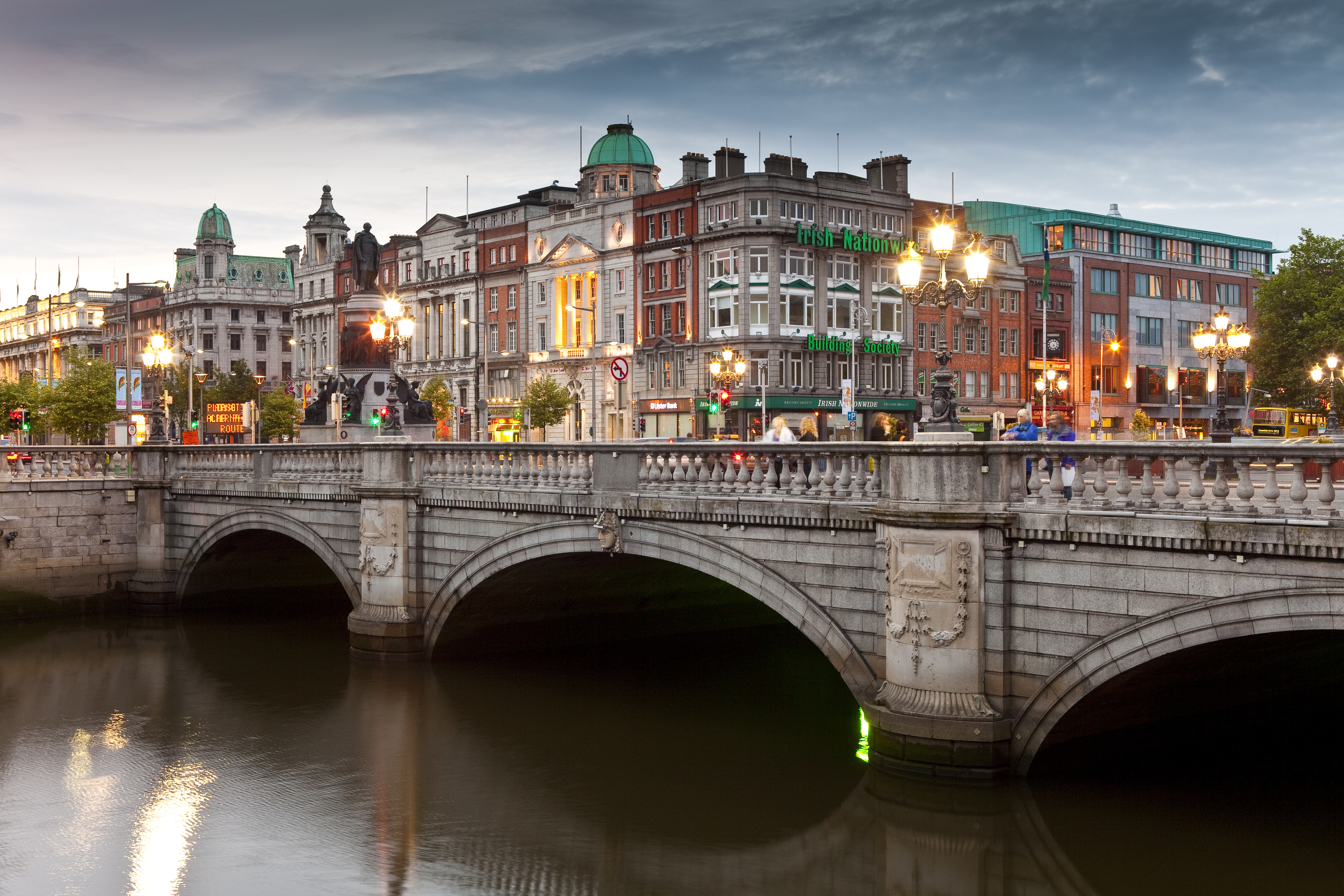 O&#x27;Connell Bridge over the River Liffey with Dublin city buildings and lights at dusk