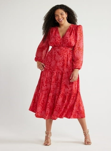 model in a red patterned dress with sheer sleeves and strappy sandals