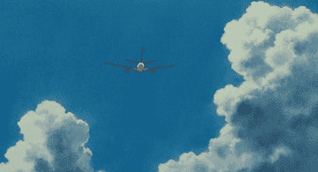 Avión volando entre nubes en un cielo despejado, representando viajes y vuelos