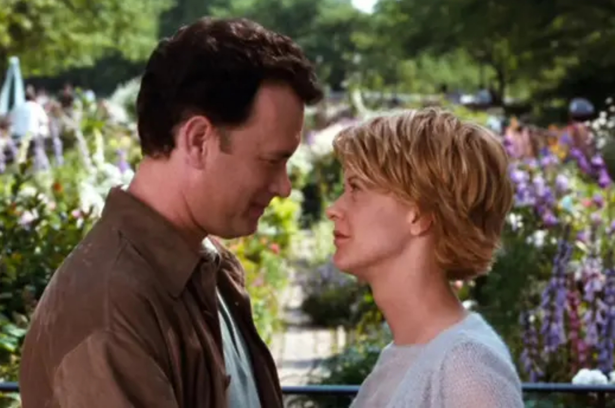 Two characters, a man and a woman, affectionately facing each other in a garden setting