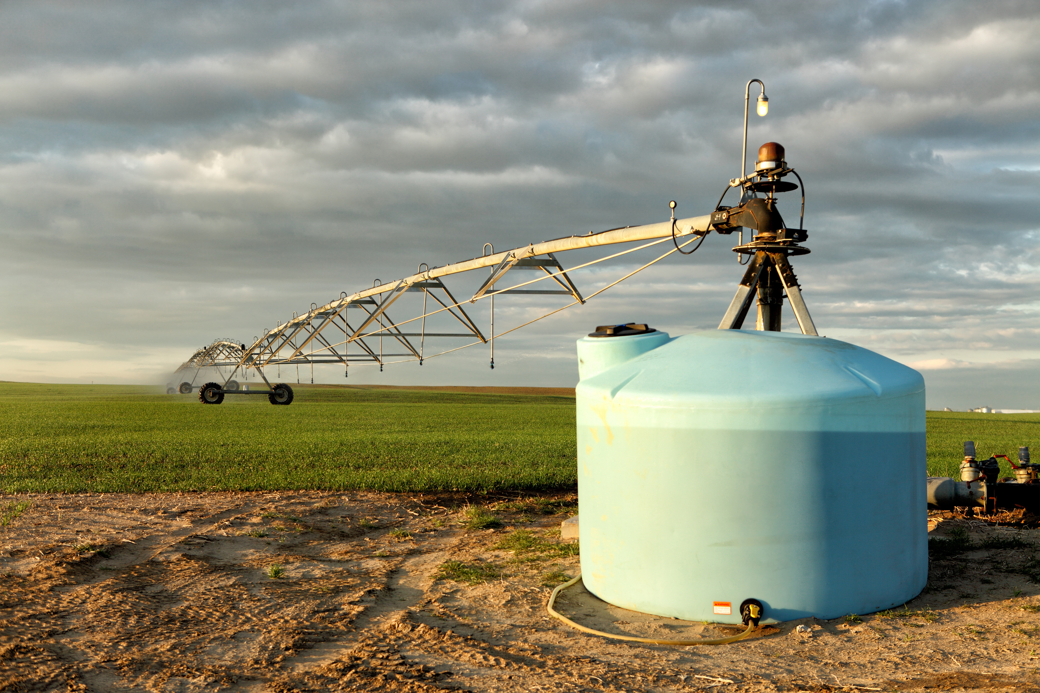Center pivot irrigation system in a field with water tank