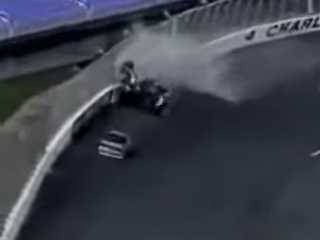Race car crashing into a barrier on a track