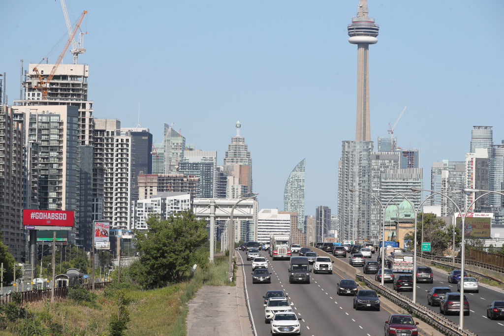 Traffic on a highway with city skyline and CN Tower in the background
