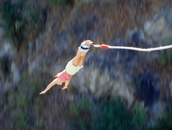 Person bungee jumping from a high platform