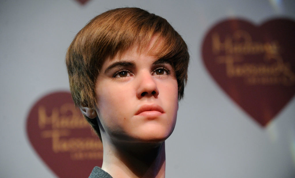 Wax figure of Justin Bieber with a serious expression, at a Madame Tussauds exhibit