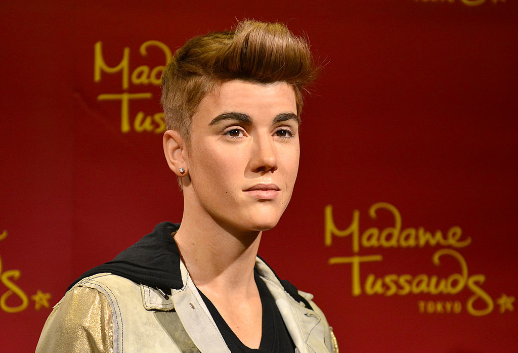 Wax figure resembling Justin Bieber, with styled hair and a casual jacket, at Madame Tussauds