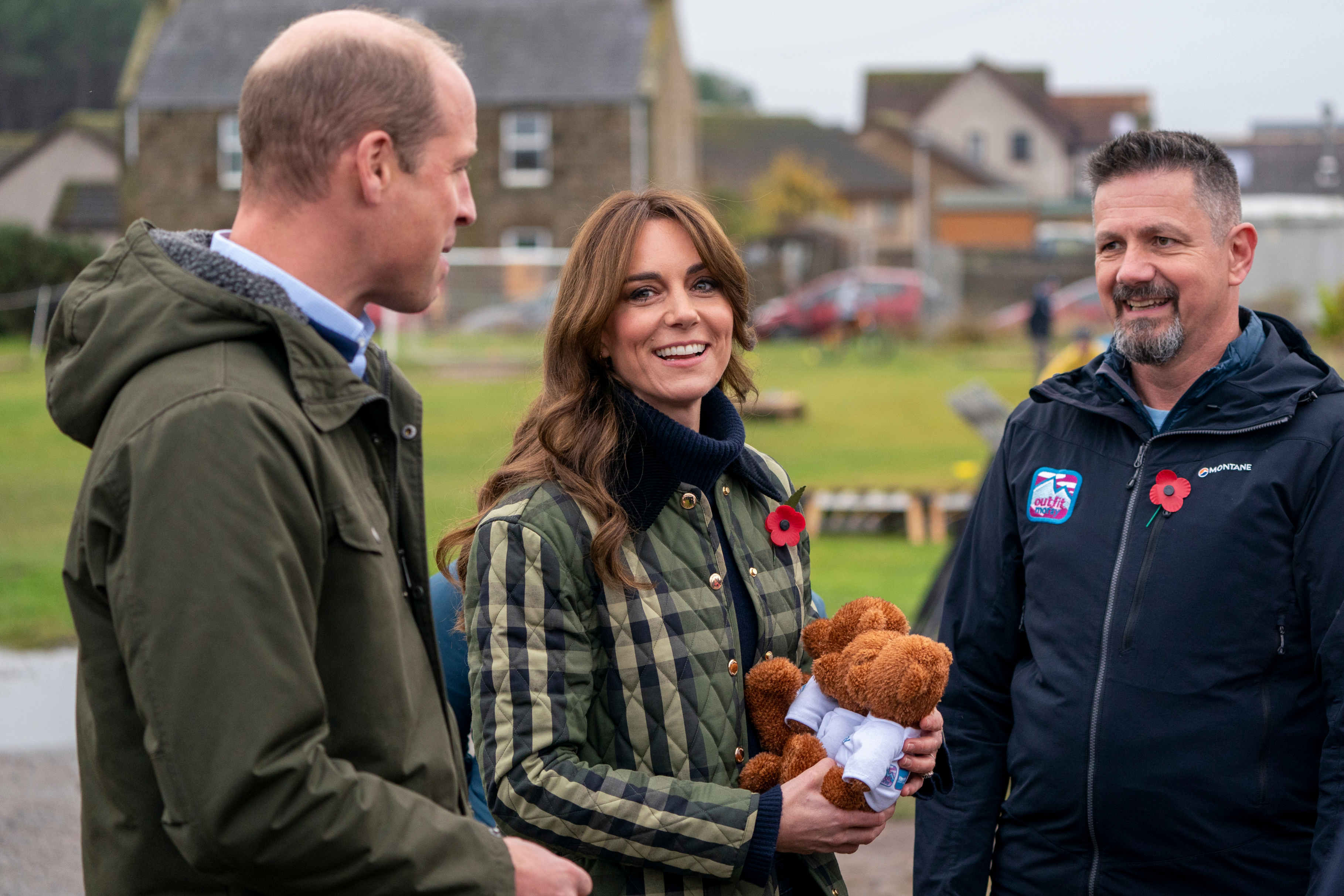 Will and Kate standing outdoors with a man