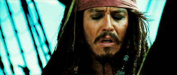 Captain Jack Sparrow appears distressed in a scene from a Pirates of the Caribbean movie