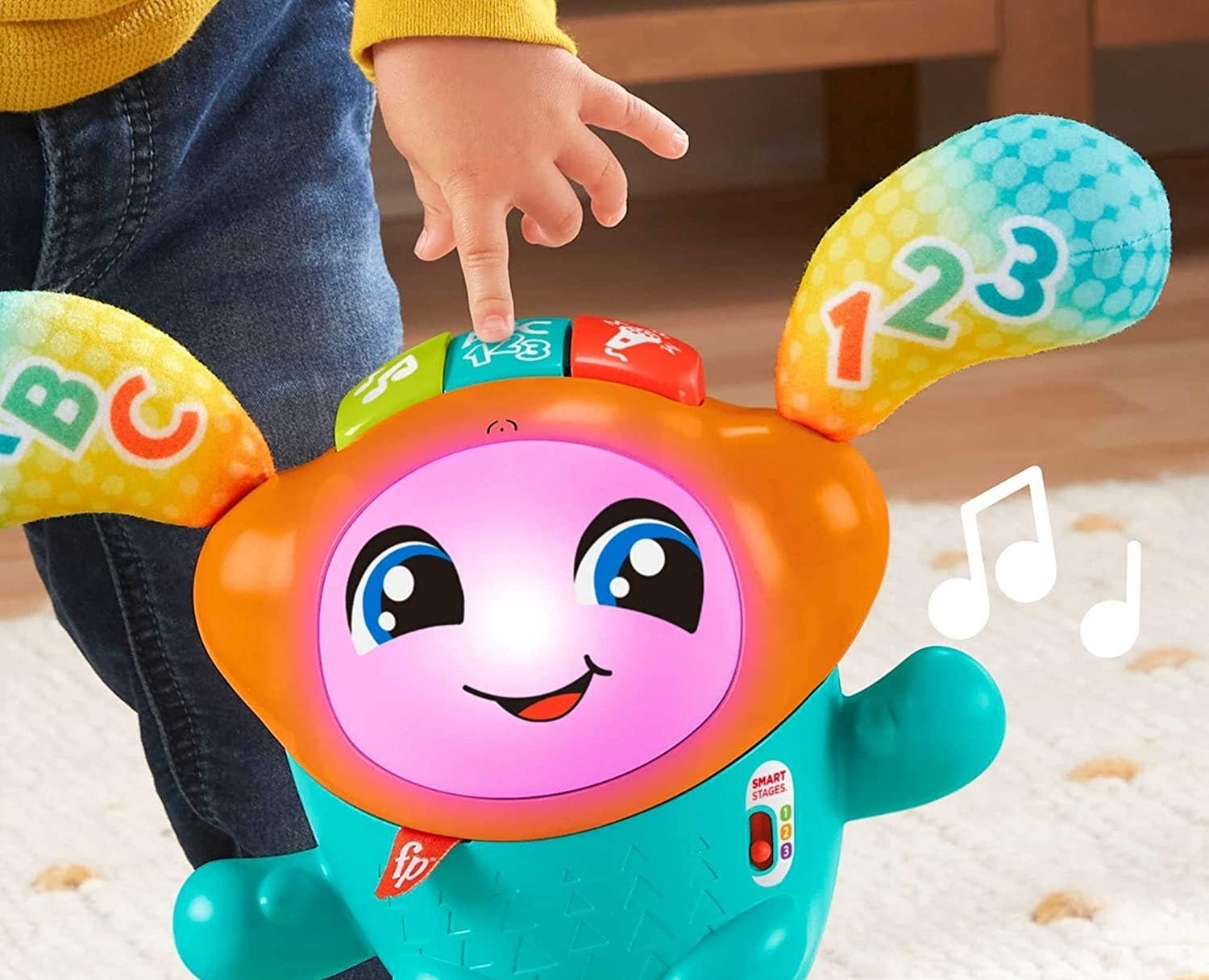 Child interacts with a colorful, musical learning toy with letters and numbers. Ideal for educational play