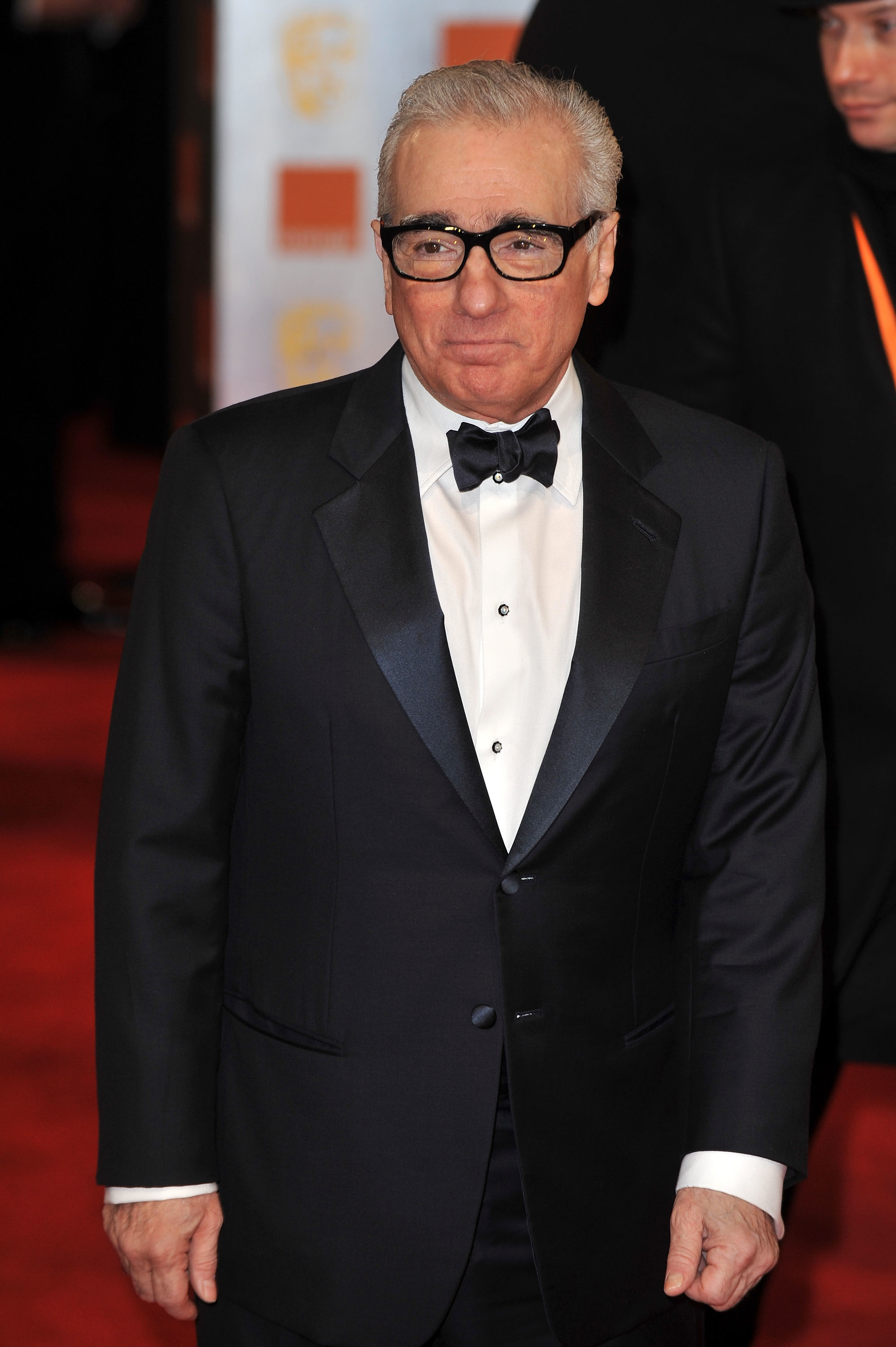 Martin Scorsese in a black suit and bow tie on the red carpet