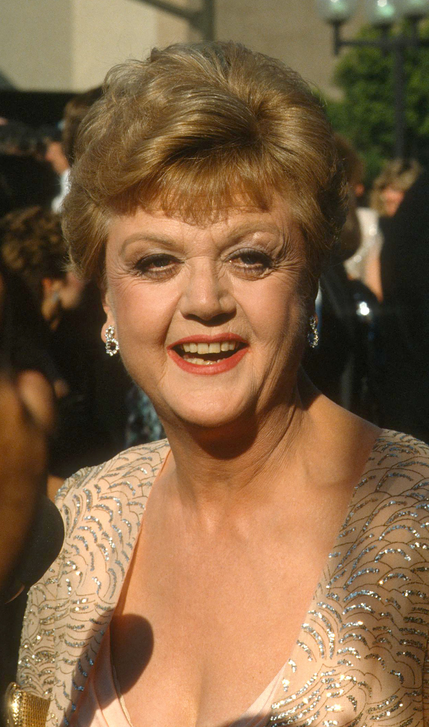 Angela Lansbury smiles in a beaded gown at an event