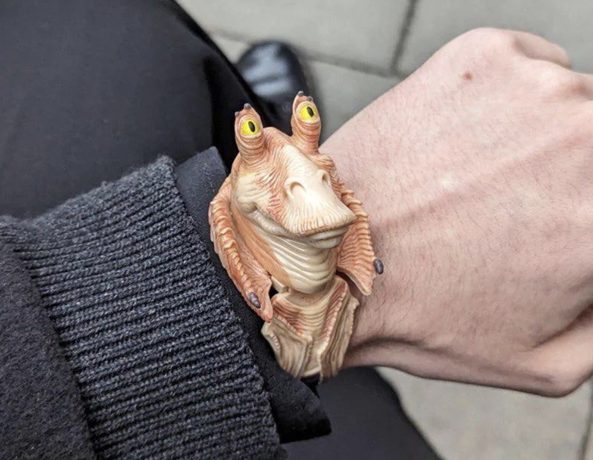 Wrist wearing a watch with a 3D figure of Jar Jar Binks from Star Wars as the face