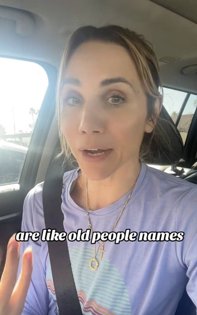 Woman in a car wearing a necklace, talking, with overlaid text about people&#x27;s names