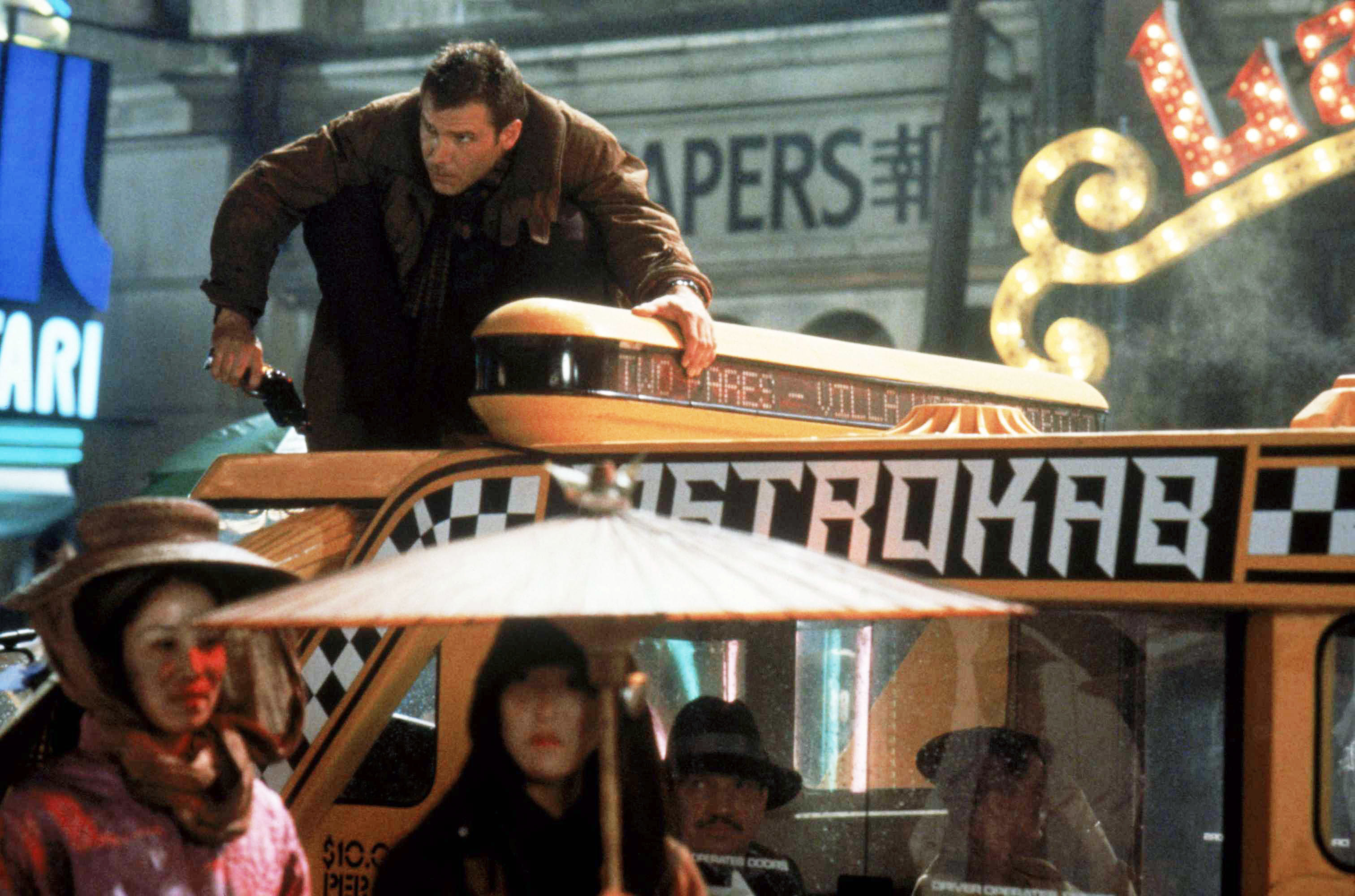 Rick atop taxi in a bustling city scene